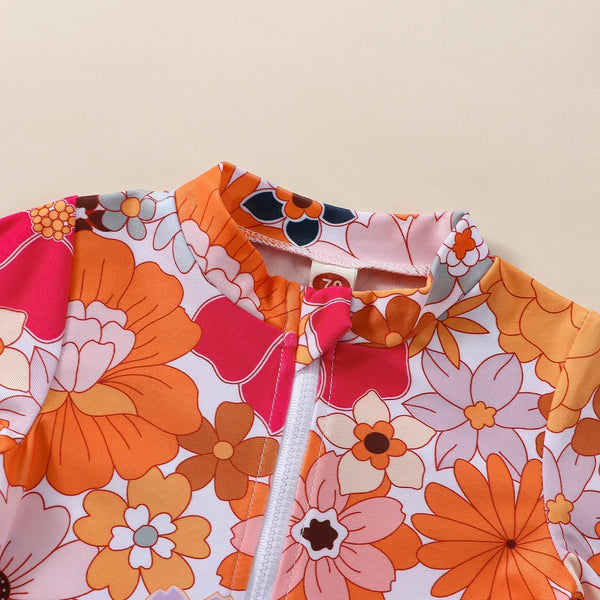 Maiô Bebê Menina Manga Longa com Zíper Frontal Estampa Floral e Babado